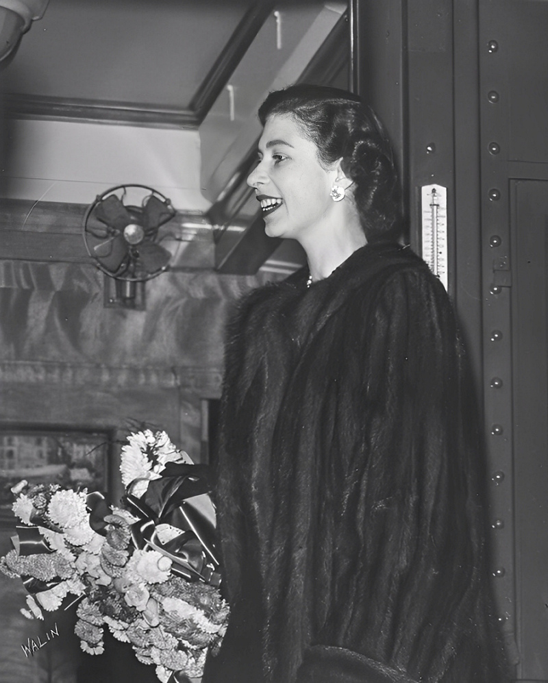 Princess Elizabeth holding a bouquet of flowers during a royal visit, shortly before her accession to the throne.
