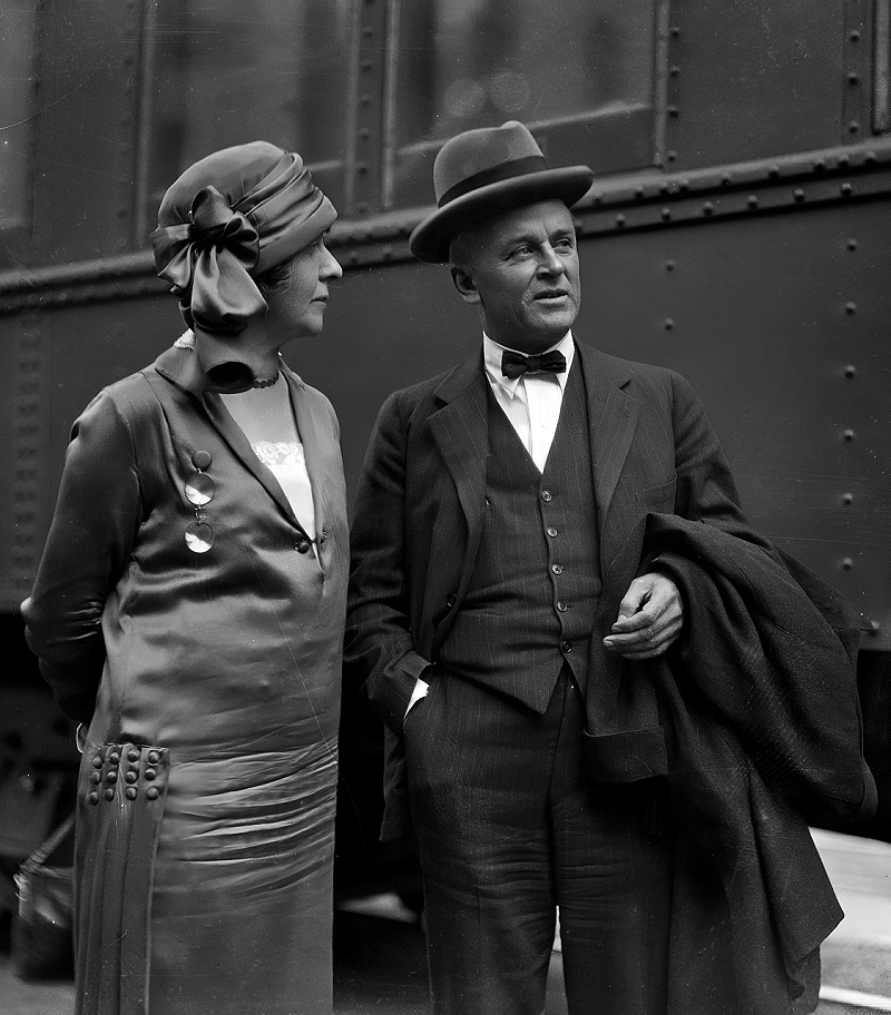 Robert A. Millikan and his wife Greta standing beside a train car in Los Angeles, between 1920 and 1939